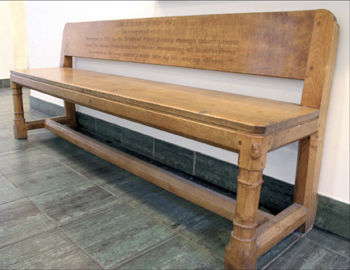 Robert Thompson ('Mouseman') bench inscribed with a dedication to Eurich - located in the Yorkshire Craft Centre